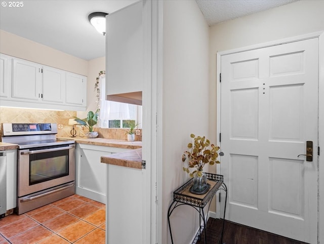8512 SW Brightfield Cir, Tigard, OR 97223 - kitchen featuring stainless steel electric range, white cabinets, and light tile patterned flooring