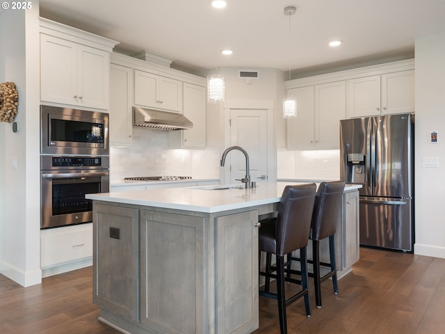 16711 NE 86th St, Vancouver, WA 98682 - kitchen featuring stainless steel appliances, under cabinet range hood, dark wood-style floors, recessed lighting, and backsplash