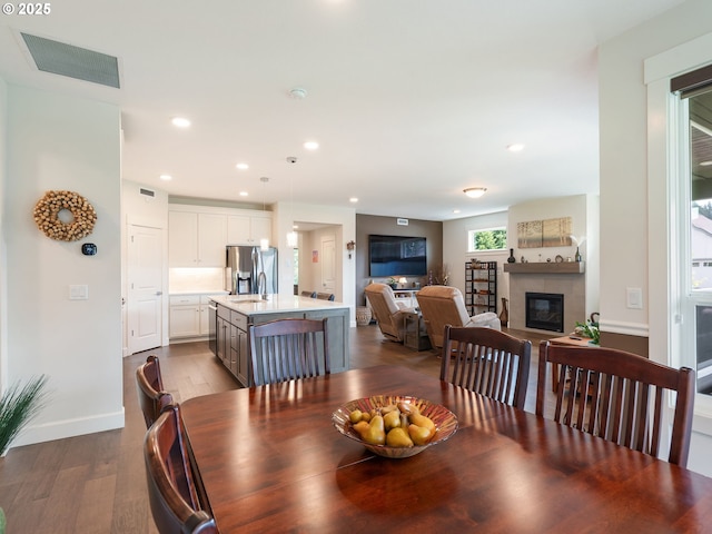 16711 NE 86th St, Vancouver, WA 98682 - dining area with a tiled fireplace, dark wood-style floors, and recessed lighting