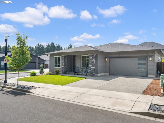 16711 NE 86th St, Vancouver, WA 98682 - prairie-style house featuring a garage, a front yard, driveway, and a shingled roof