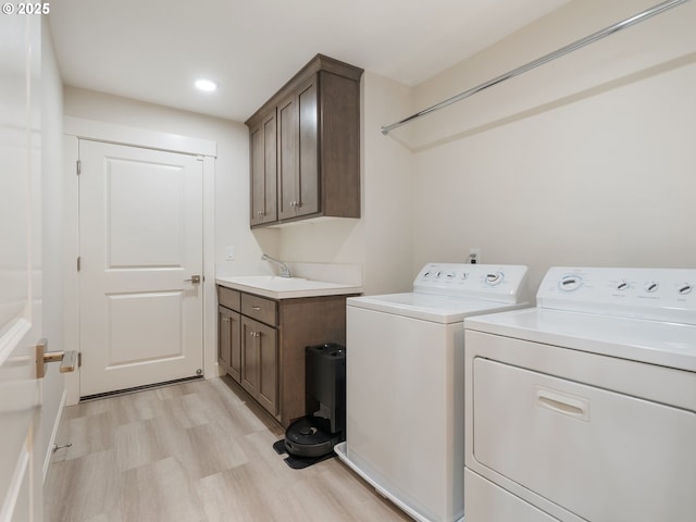 16711 NE 86th St, Vancouver, WA 98682 - laundry room featuring washing machine and dryer, cabinet space, light wood finished floors, and recessed lighting