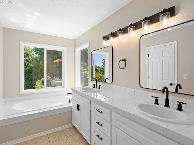 12576 NW Maplecrest Way, Banks, OR 97106 - full bathroom with double vanity, a garden tub, and tile patterned floors