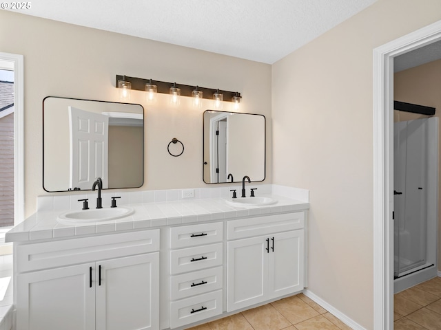 12576 NW Maplecrest Way, Banks, OR 97106 - bathroom featuring tile patterned flooring, double vanity, and a shower with shower door