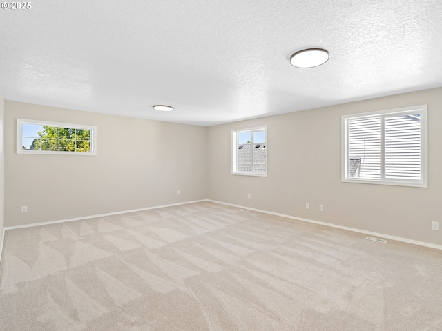 12576 NW Maplecrest Way, Banks, OR 97106 - empty room featuring light colored carpet and a textured ceiling