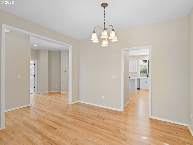 12576 NW Maplecrest Way, Banks, OR 97106 - empty room with light wood-type flooring and a chandelier