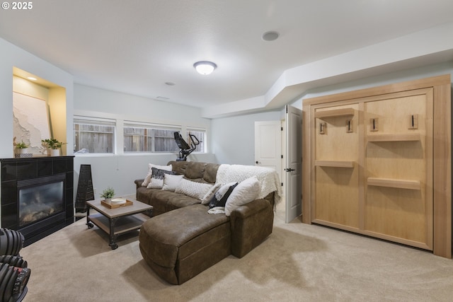 living area featuring carpet flooring and a tile fireplace