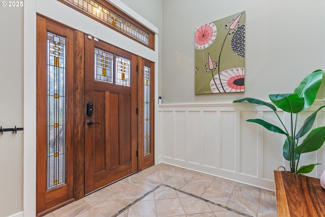 foyer entrance featuring wainscoting