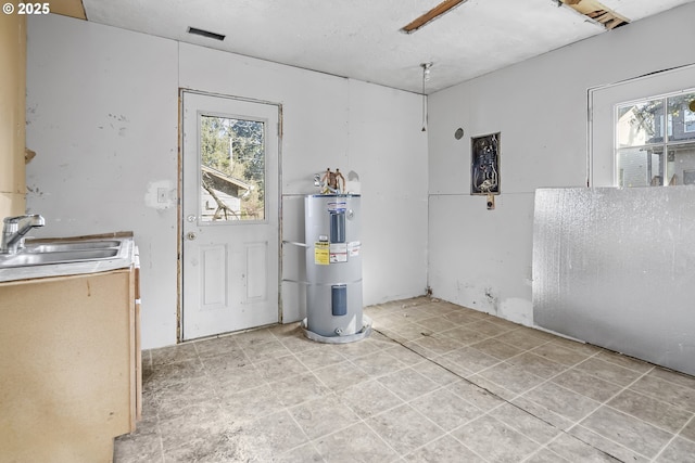 interior space with water heater and a sink