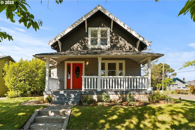 view of front facade with a front lawn and a porch