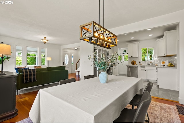 dining area featuring a healthy amount of sunlight, dark wood-type flooring, recessed lighting, and visible vents