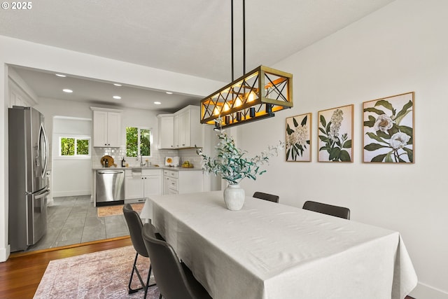 dining room featuring baseboards, recessed lighting, and wood finished floors