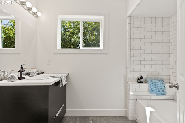 full bathroom featuring walk in shower, a bathtub, baseboards, and vanity
