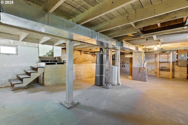below grade area featuring stairway and heating unit