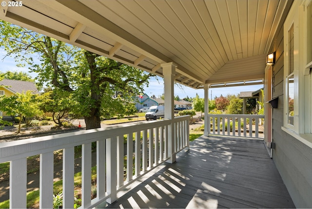 wooden deck featuring a porch and a residential view