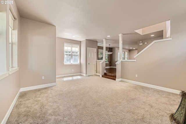 unfurnished living room featuring carpet flooring, recessed lighting, and baseboards