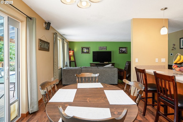 dining area featuring dark wood-type flooring