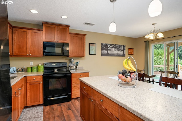 kitchen with pendant lighting, black appliances, a textured ceiling, dark hardwood / wood-style flooring, and a chandelier