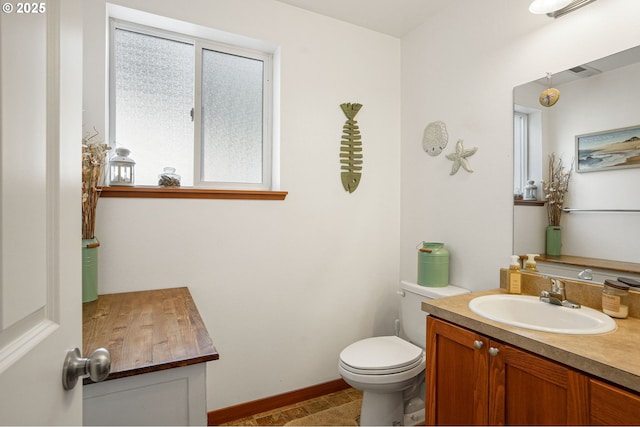 bathroom featuring vanity and toilet