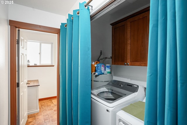 washroom featuring cabinets and washer and dryer