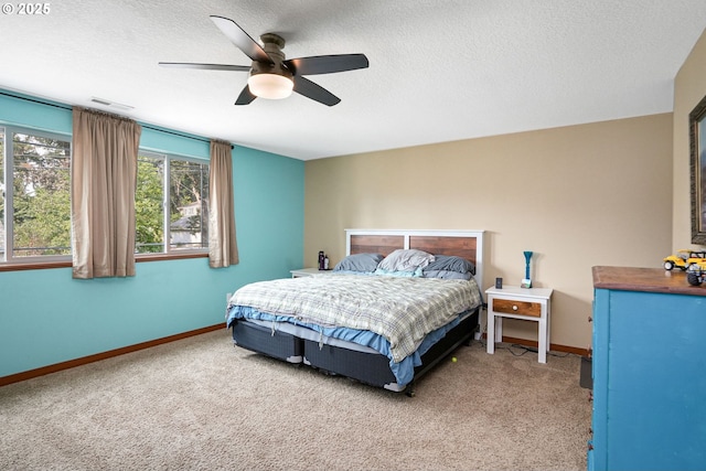 bedroom with carpet flooring, ceiling fan, and a textured ceiling