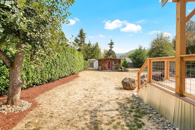 view of yard with a mountain view and an outdoor structure