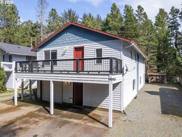 370 4th Pl, Manzanita, OR 97130 - view of front facade with a garage, a deck, concrete driveway, and stairs