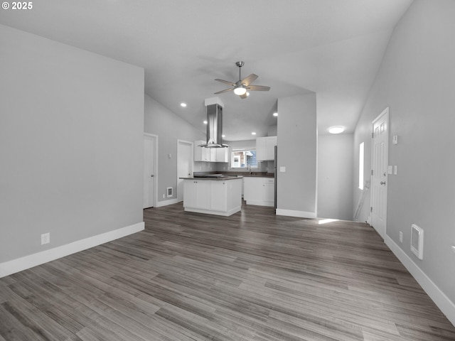 370 4th Pl, Manzanita, OR 97130 - unfurnished living room featuring ceiling fan, vaulted ceiling, baseboards, recessed lighting, and dark wood-style flooring