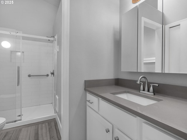 370 4th Pl, Manzanita, OR 97130 - full bath featuring vanity, toilet, a shower stall, and wood finished floors