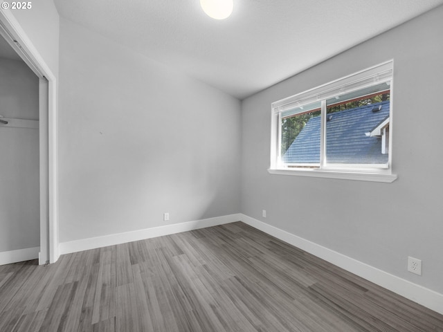 370 4th Pl, Manzanita, OR 97130 - unfurnished bedroom featuring wood finished floors, baseboards, and a closet