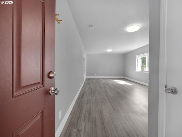 370 4th Pl, Manzanita, OR 97130 - empty room featuring baseboards, wood finished floors, and a smoke detector