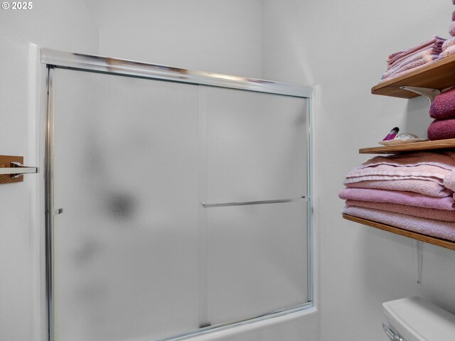 370 4th Pl, Manzanita, OR 97130 - bathroom featuring a shower with shower door and toilet