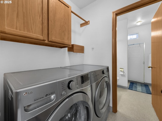 370 4th Pl, Manzanita, OR 97130 - laundry room featuring washing machine and dryer, cabinet space, and light colored carpet
