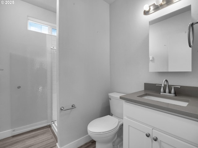 370 4th Pl, Manzanita, OR 97130 - full bath featuring vanity, wood finished floors, a shower stall, toilet, and baseboards