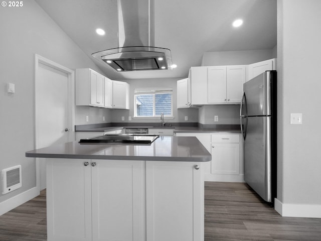 370 4th Pl, Manzanita, OR 97130 - kitchen featuring freestanding refrigerator, baseboards, island exhaust hood, white cabinetry, and recessed lighting