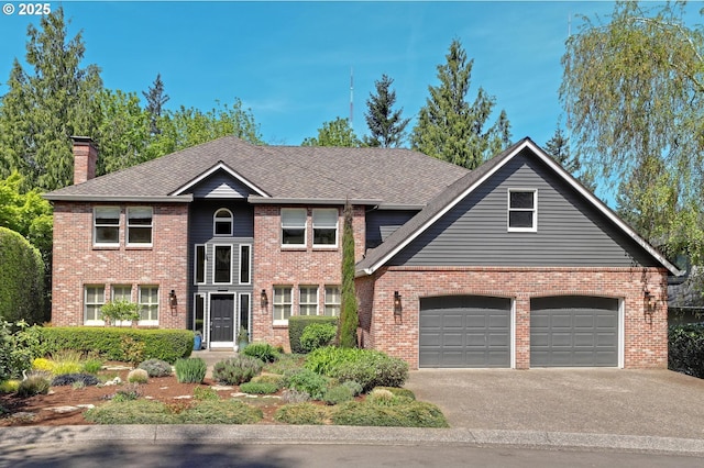 traditional home featuring concrete driveway, brick siding, a chimney, and a garage