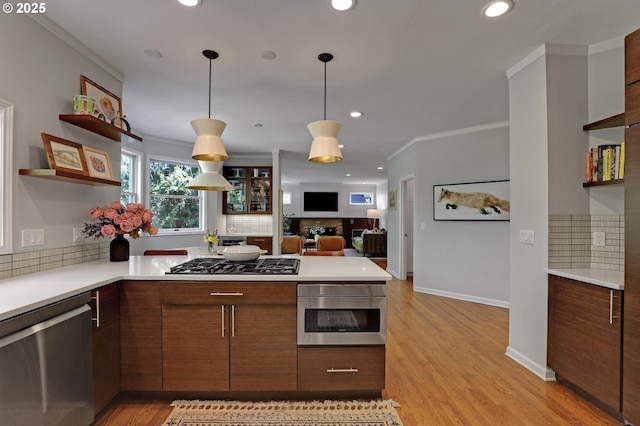 kitchen featuring light countertops, appliances with stainless steel finishes, and open shelves