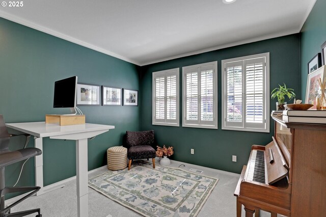 carpeted office space featuring baseboards, ornamental molding, and visible vents