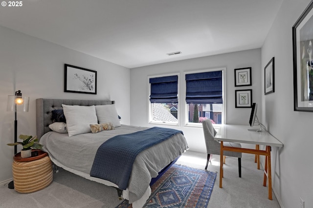 carpeted bedroom featuring visible vents