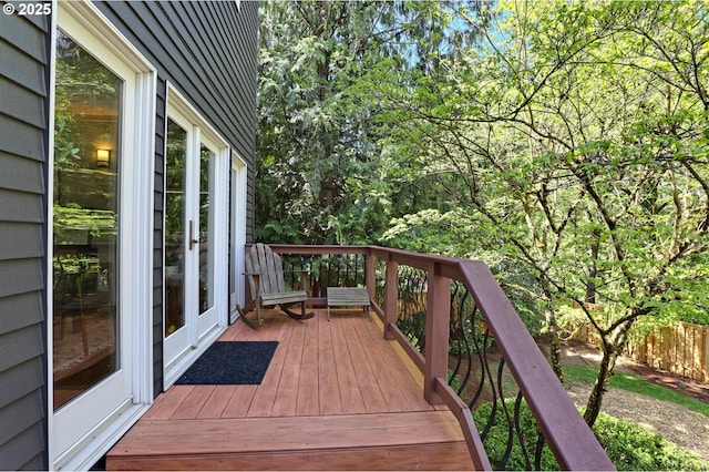 wooden terrace with a fenced backyard