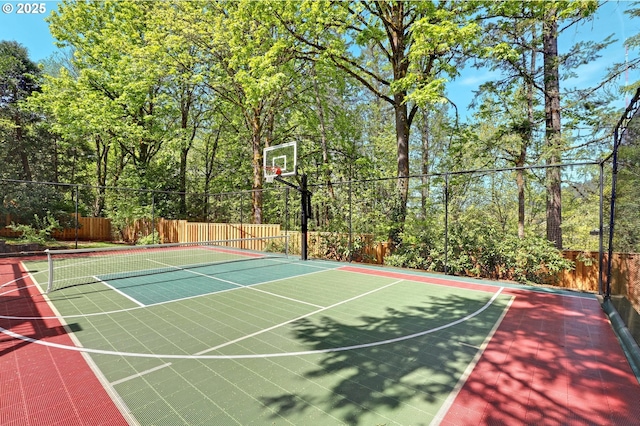 view of basketball court with fence and a tennis court
