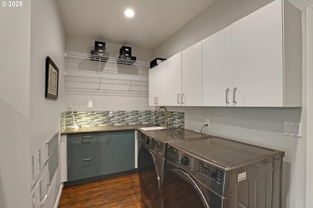 washroom featuring independent washer and dryer, dark wood finished floors, cabinet space, a sink, and recessed lighting