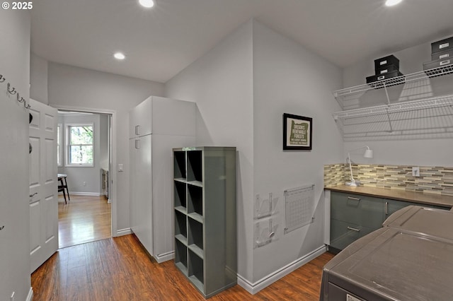 interior space featuring recessed lighting, baseboards, and dark wood finished floors