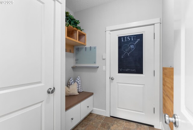 18287 SW Florendo Ln, Beaverton, OR 97007 - mudroom with baseboards and dark stone finish flooring
