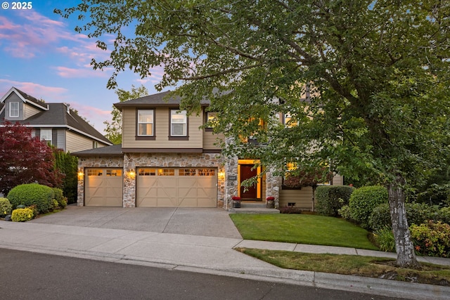 18287 SW Florendo Ln, Beaverton, OR 97007 - view of front of house featuring concrete driveway, stone siding, a front yard, and a garage