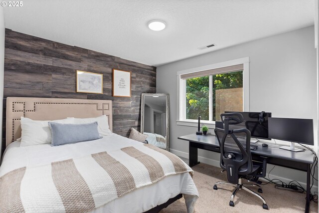 18287 SW Florendo Ln, Beaverton, OR 97007 - bedroom with an accent wall, wooden walls, carpet flooring, and an office area