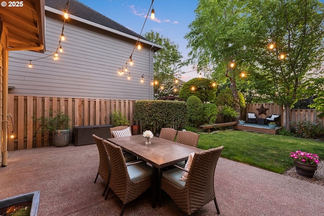 18287 SW Florendo Ln, Beaverton, OR 97007 - patio terrace at dusk featuring a fenced backyard, a patio area, and outdoor dining area