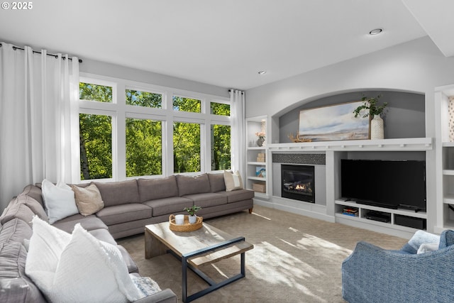 18287 SW Florendo Ln, Beaverton, OR 97007 - living room featuring built in features, a glass covered fireplace, carpet floors, and recessed lighting