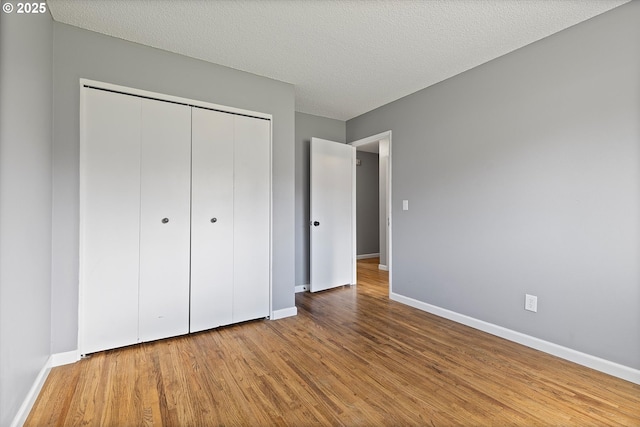 721 NW 76th St, Vancouver, WA 98665 - unfurnished bedroom featuring wood finished floors, baseboards, and a closet