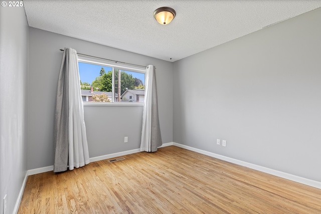 721 NW 76th St, Vancouver, WA 98665 - unfurnished room featuring light wood-style floors, baseboards, and a textured ceiling