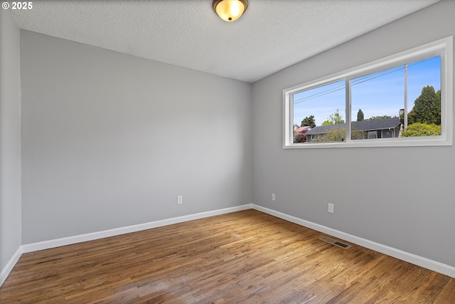 721 NW 76th St, Vancouver, WA 98665 - empty room with wood finished floors, baseboards, and a textured ceiling
